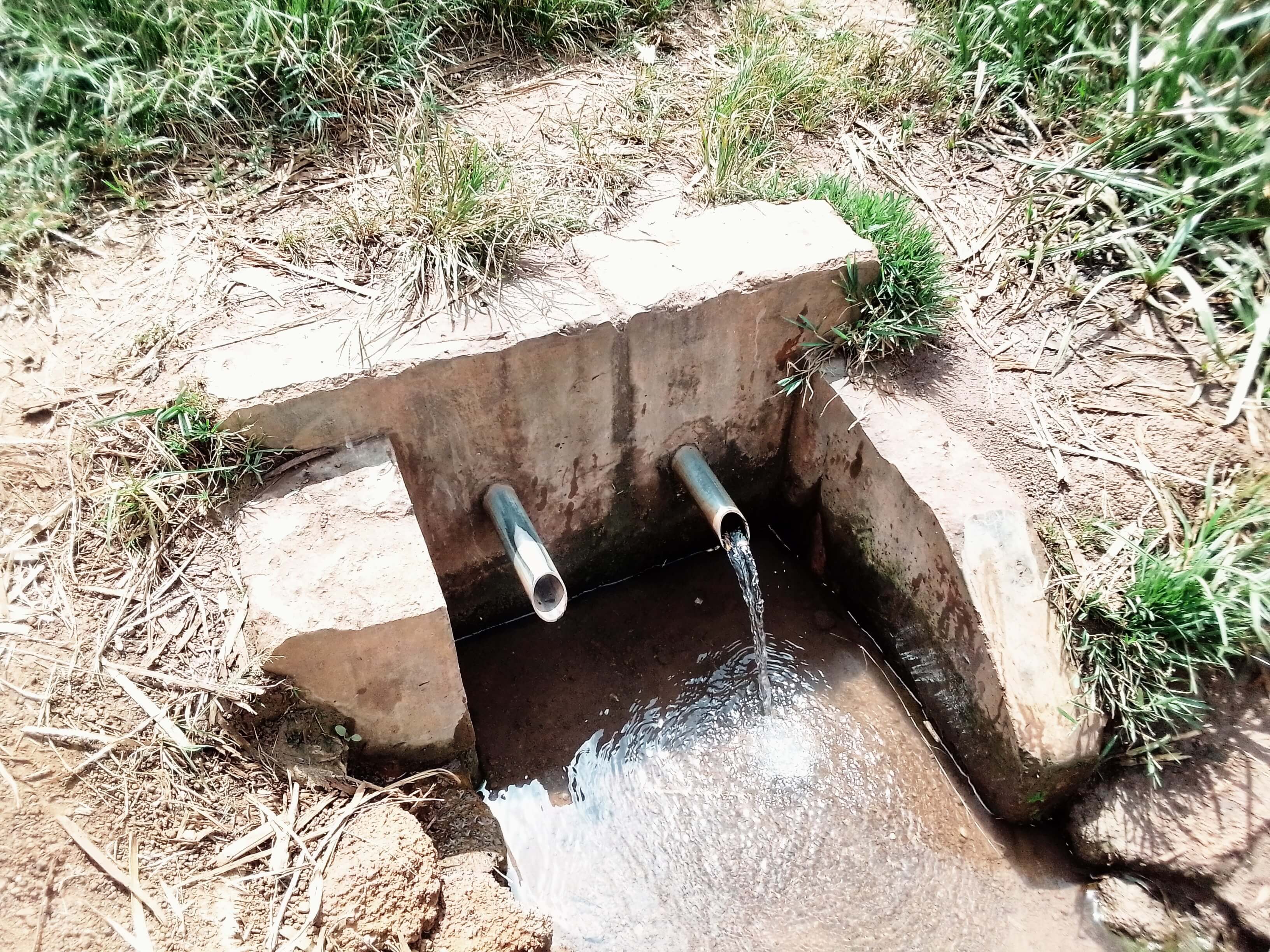 image of clean water flowing though pipes in drain in landscape