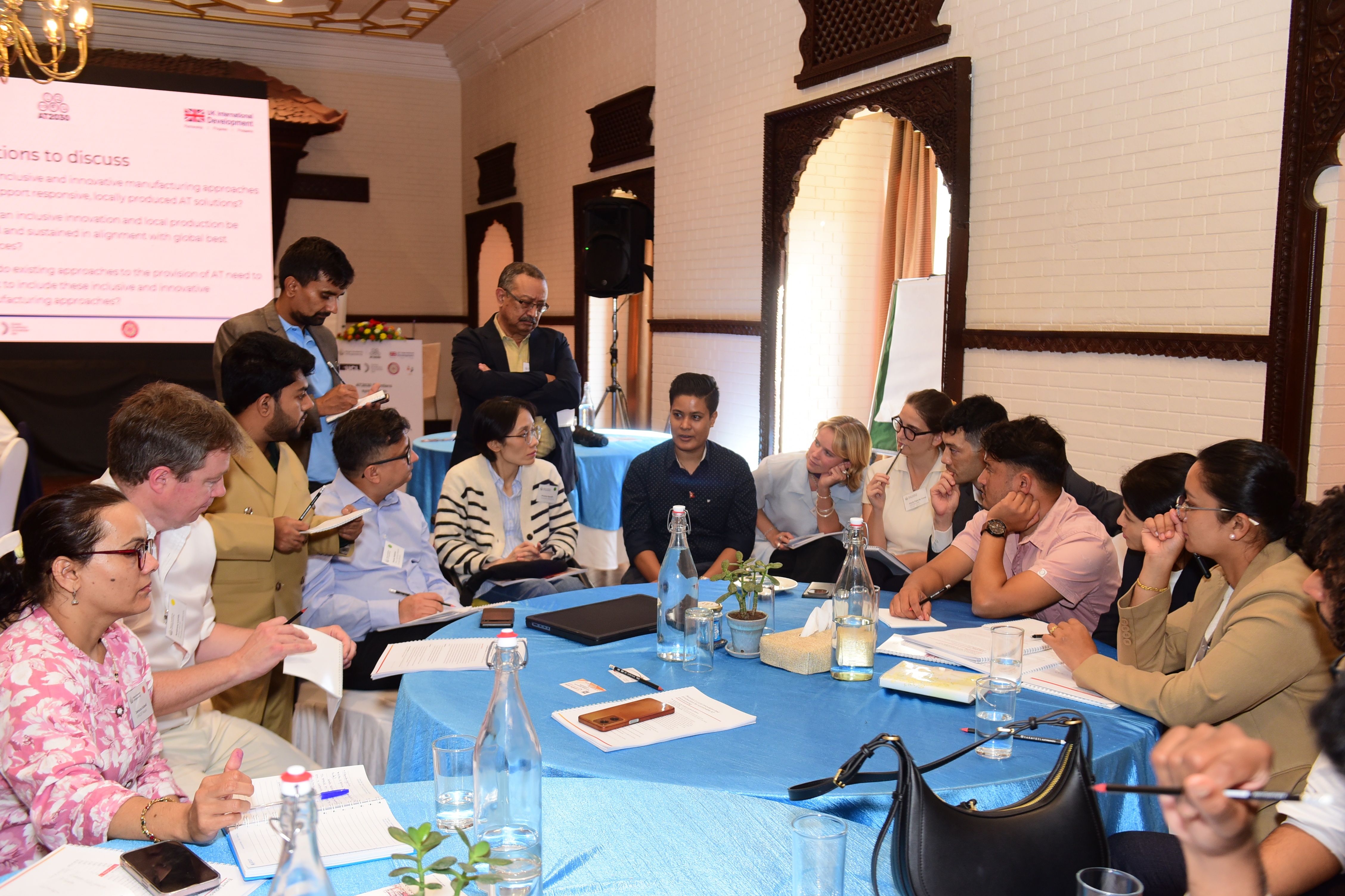 Participants gather around the table during Session 1 discussions