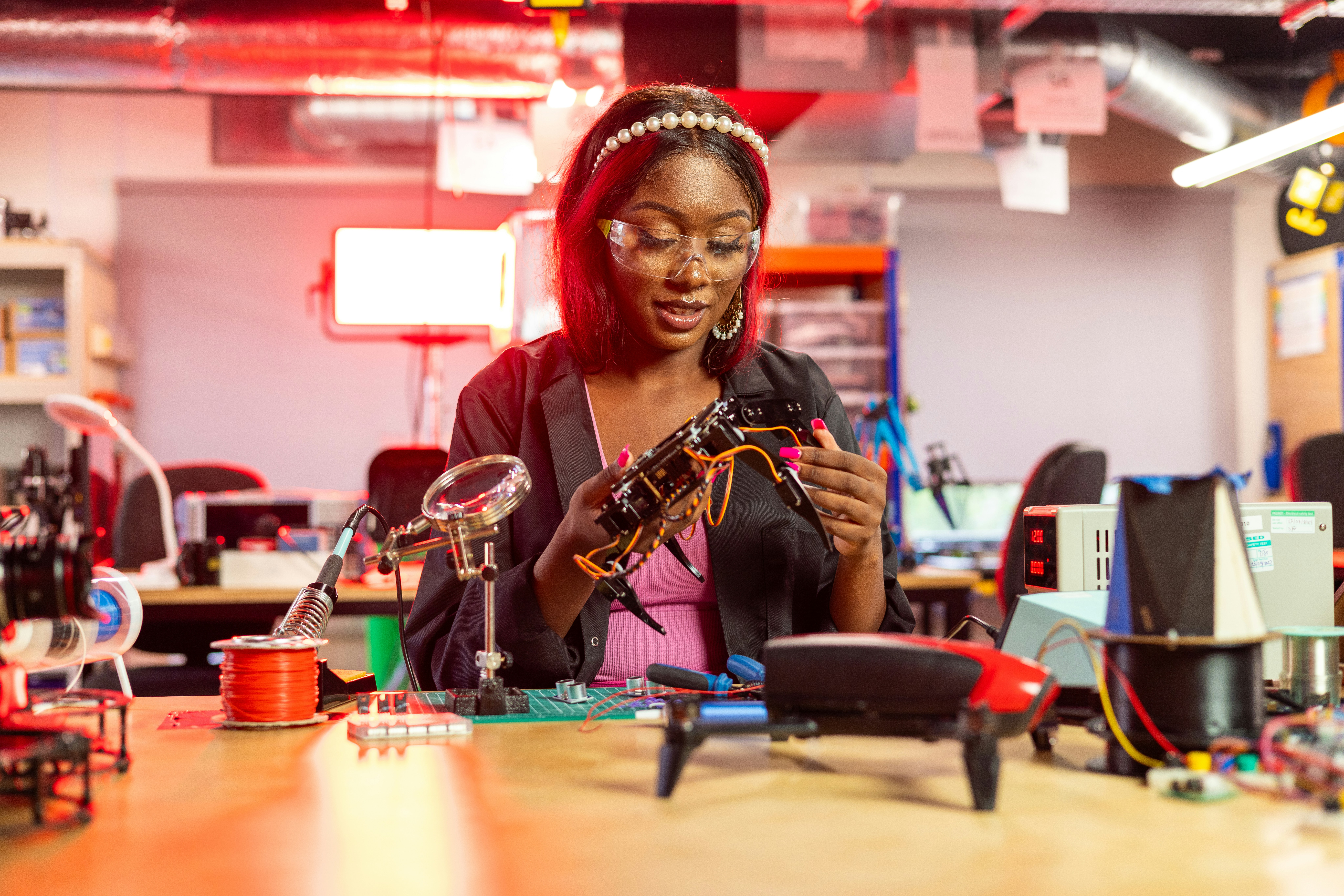 A female engineer working with some tools on a desk
