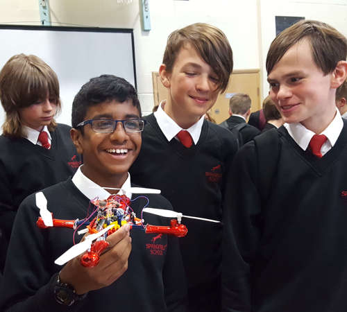 Group of school boys showcasing a drone project.