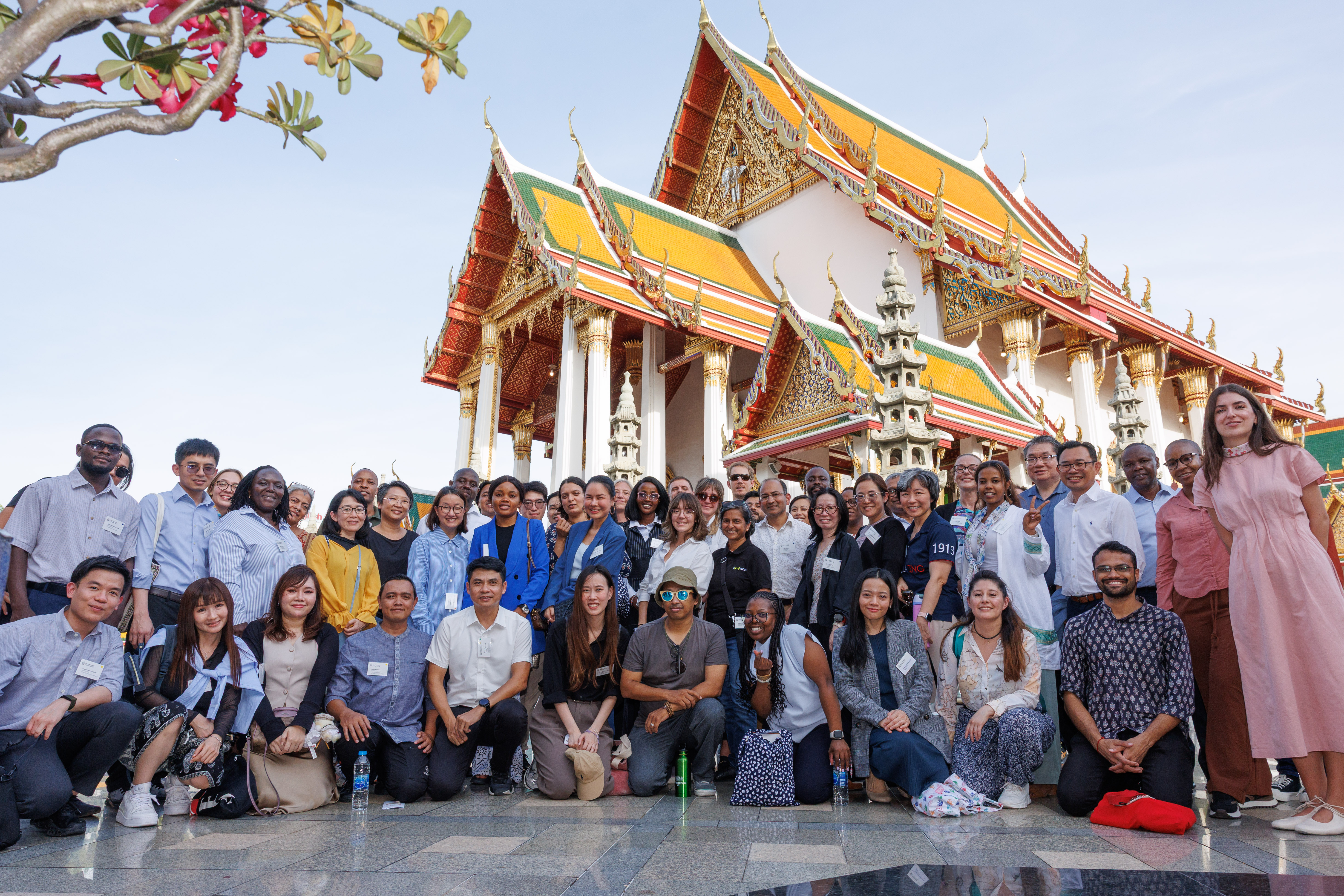 Group picture of symposium participants in front of Wat Suthat in Bangkok, Thailand