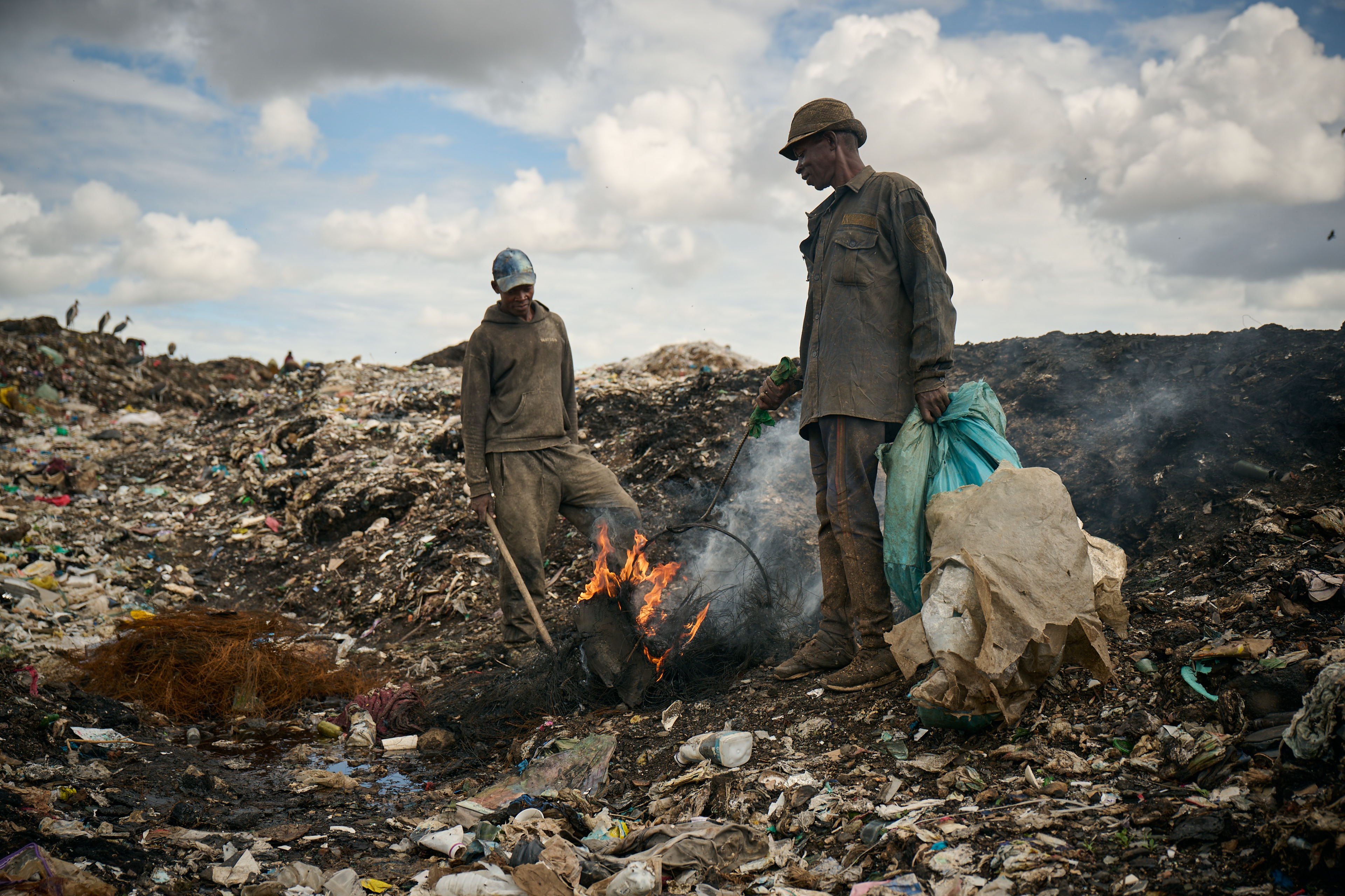 Workers at the Dandora dumpsite in Nairobi, Kenya, where open burning of waste has a significant impact on human health