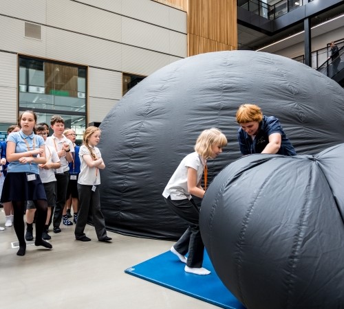 A group of students entering an inflatable dome