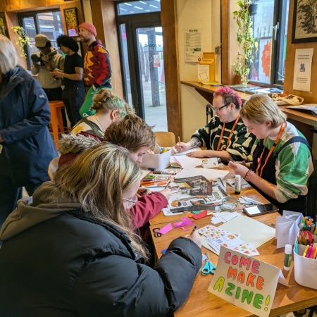 A group of people drawing and creating comics on a table
