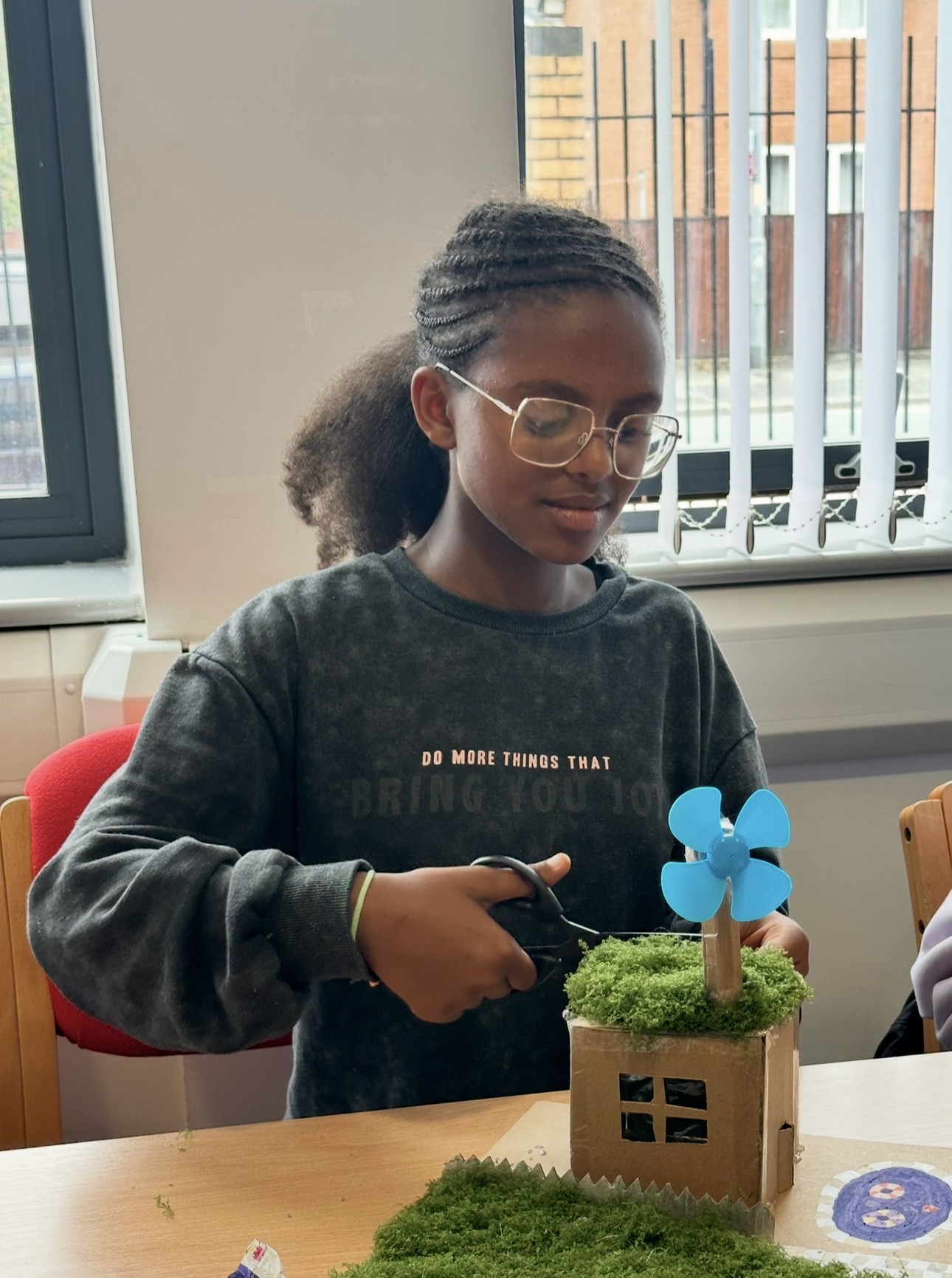 A young girl working on a model