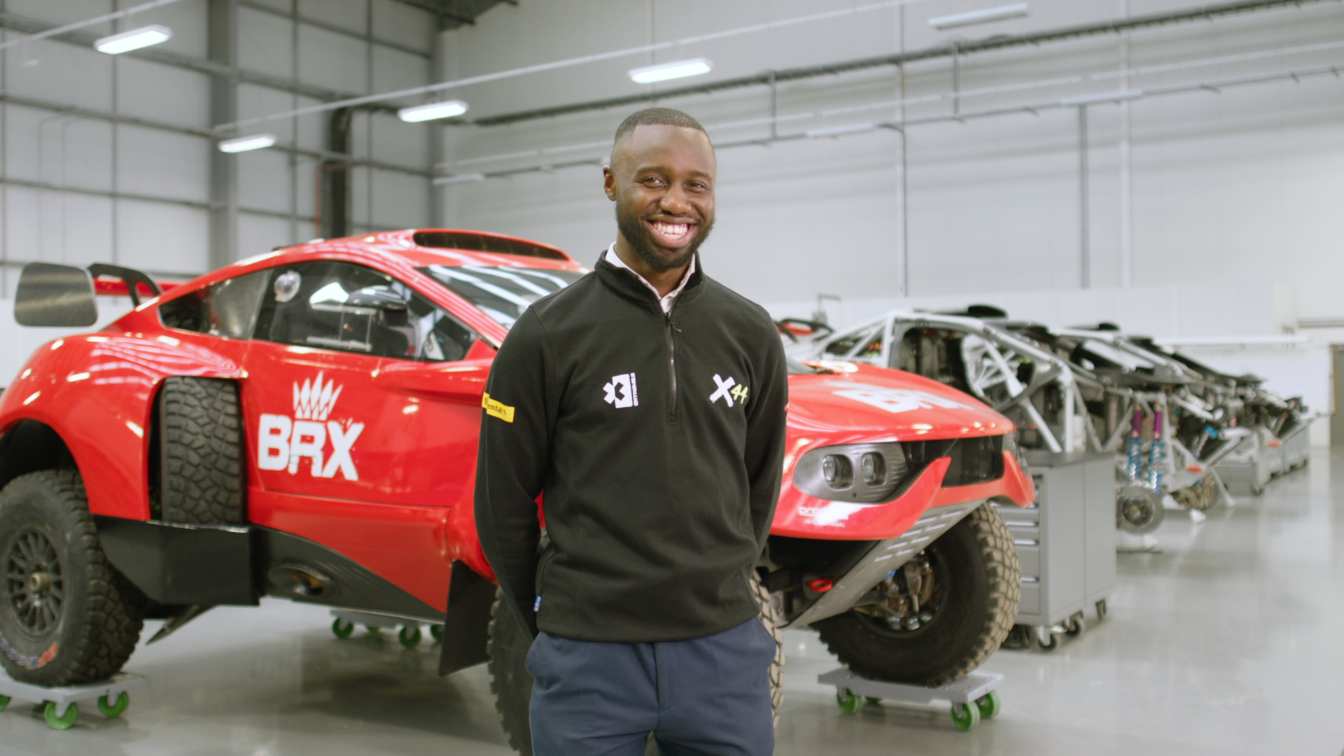 George Imafidon in front of a racing car