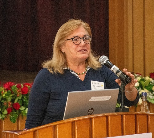 Professor Alicia presenting in front of participants