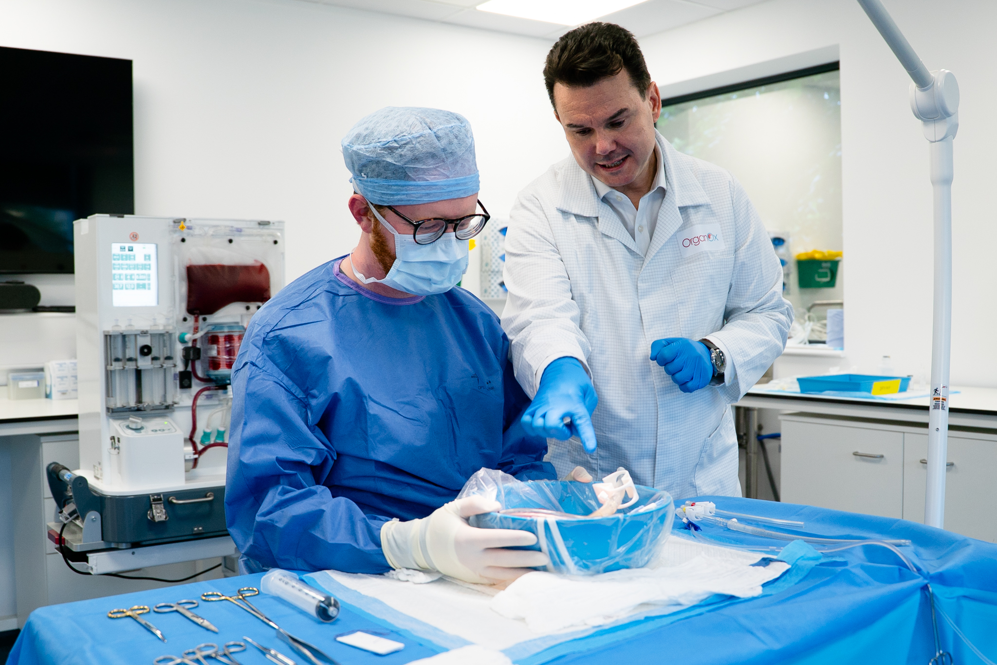 Clinician and engineer reviewing organ perfusion technology in a laboratory