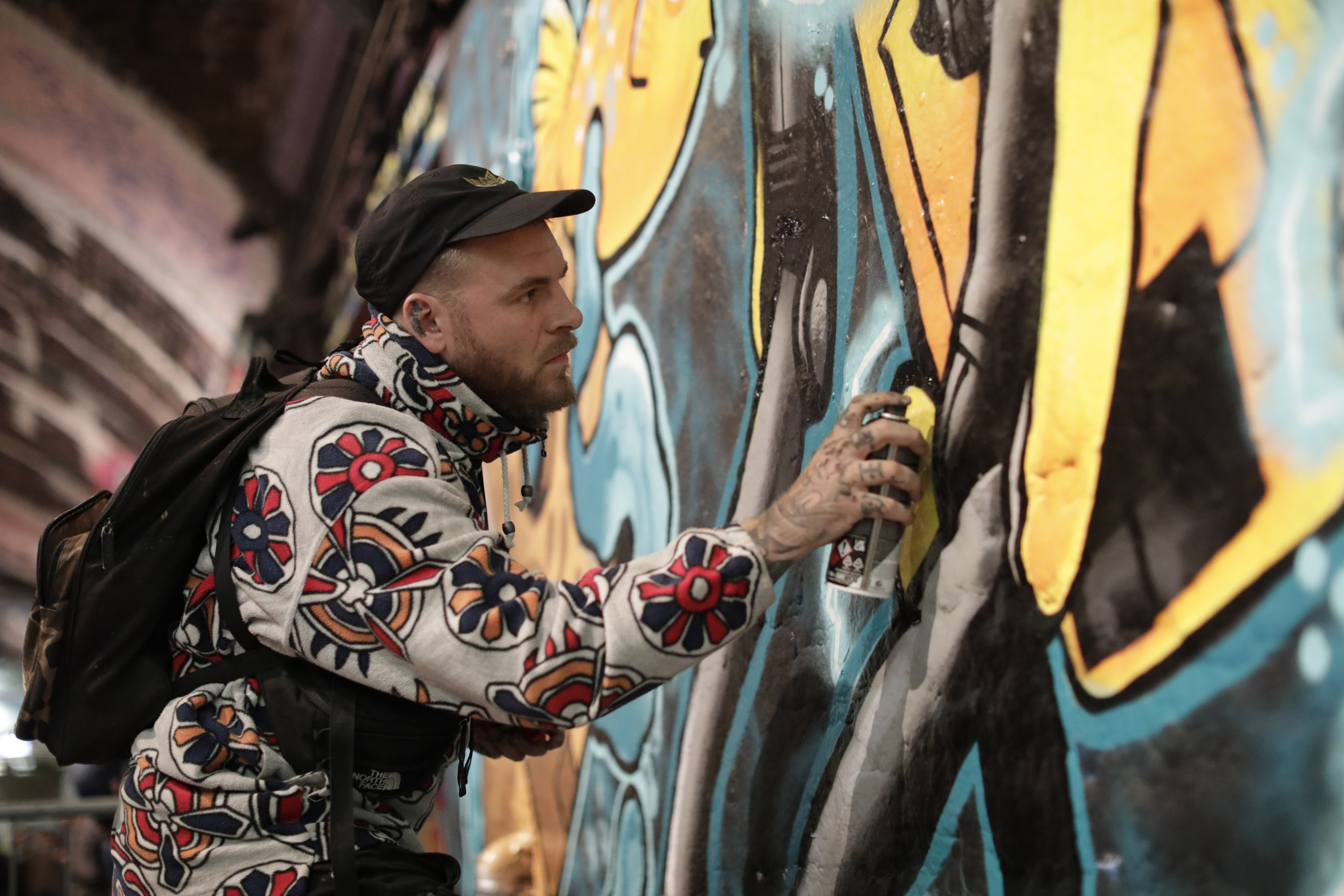 Graffiti artist Caeman Smith creates an engineering inspired artwork in the Leake Street tunnels