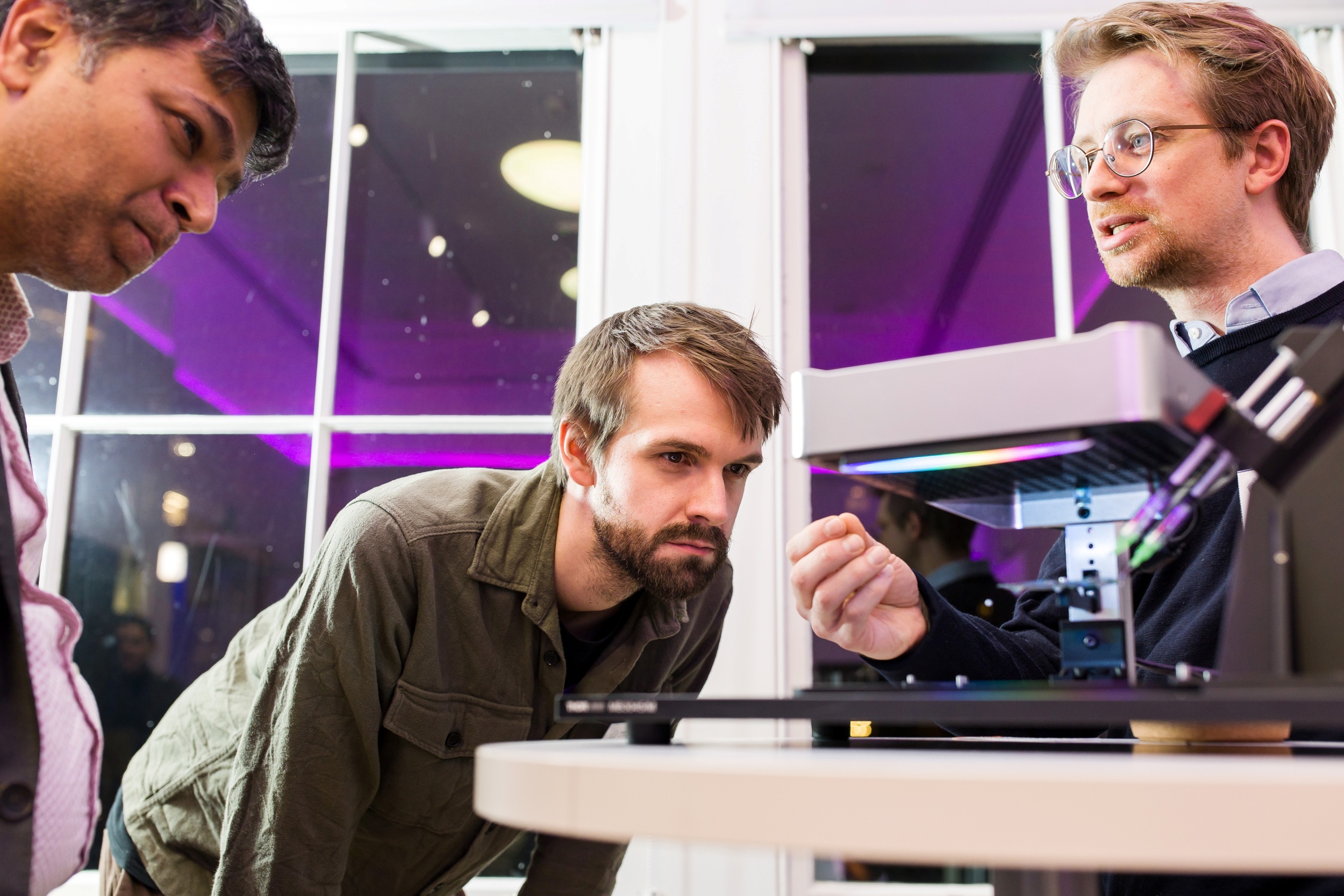 Participants examining a technology demonstration at an innovation showcase.
