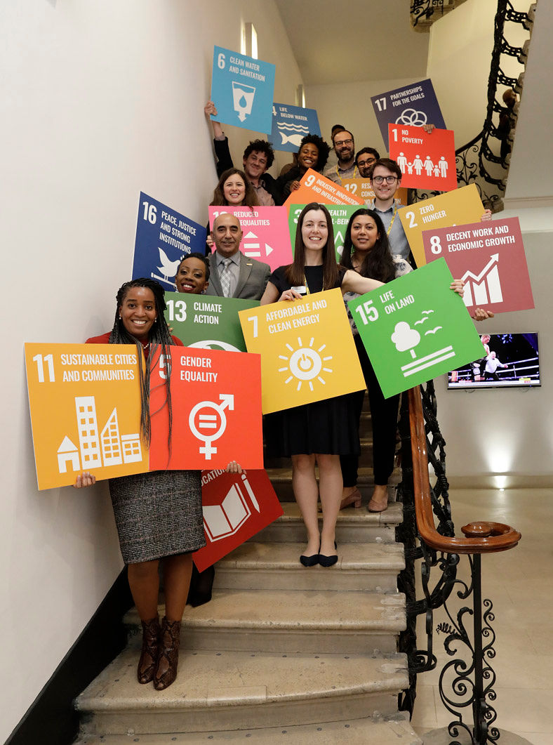 academy staff posing with SDG sign sin Prince Philip House