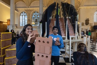 Students building a recreation of St Paul's dome inside a church