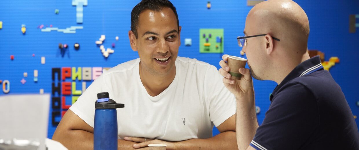 two engineers chatting with drinks