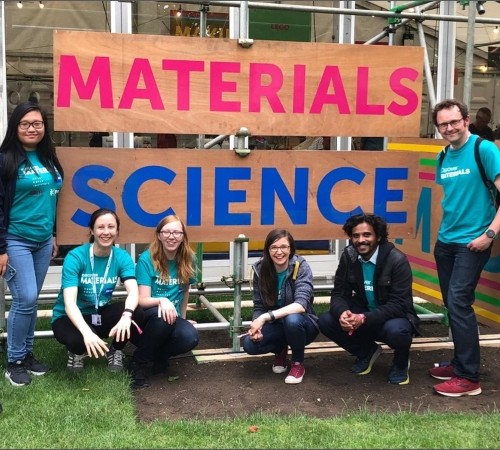 A group photo of the team with a big sign saying "Materials Science"