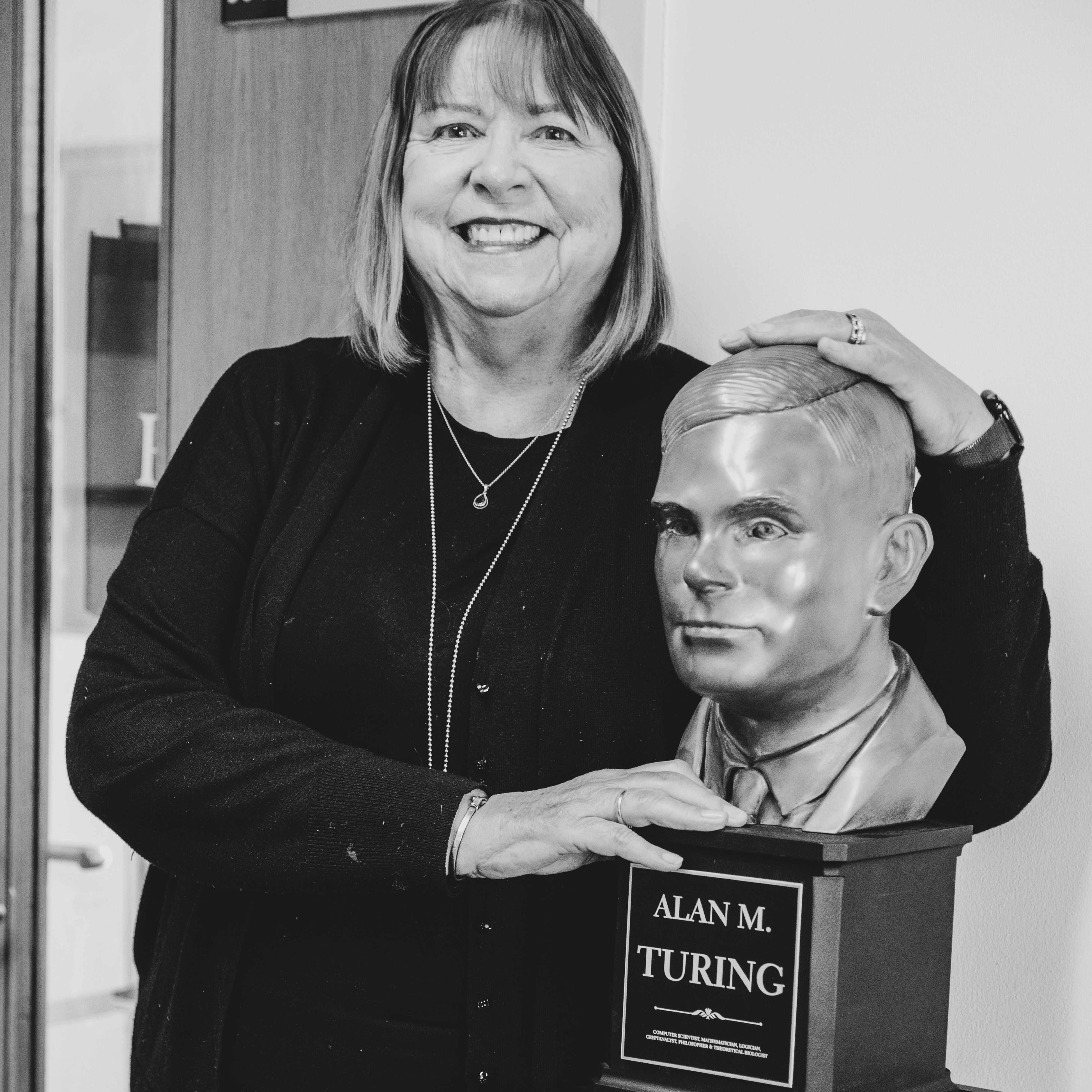 Professor Dame Wendy Hall posing with bust of Alan Turing