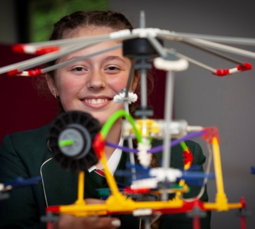 A student standing at the back of a model